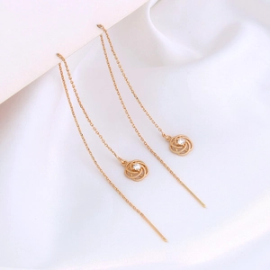 Detail of elegant gold rose long chain drop earrings with sparkling zircon inlay