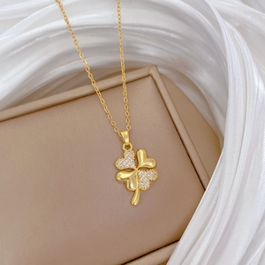 Luxurious four-leaf clover necklace with sparkling rhinestones on an elegant jewelry box