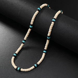 Detailed macro view of handmade beaded necklace with turquoise spacers and beige round beads