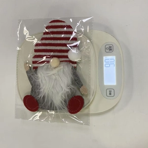 Close-up showing the 9.0g weight of a Christmas gnome cutlery bag on a digital scale