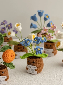 Detail of crochet emotional support plant with motivational card and colorful flowers