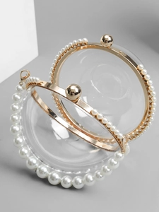 Elegant transparent handbag with gold metal frame and pearl handle for wedding or party