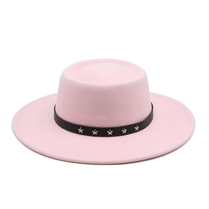 Detail of pink wool fedora featuring black band and silver star studs on white background