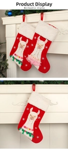 Detailed embroidery of festive alpacas on red velvet Christmas stockings hanging on a mantel