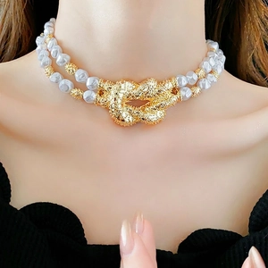 French style double-layer pearl choker with oversized gold knot pendant worn by model
