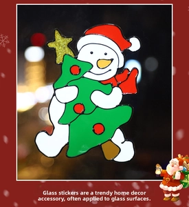 Detail of Christmas window sticker featuring a snowman hugging a festive tree on glass