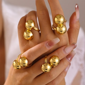 Exaggerated open gold rings with geometric spheres in 18k gold-plated copper on a hand