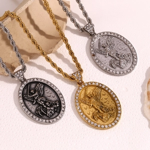 Detailed view of 18K gold and silver angel necklaces with rhinestone-encrusted pendants