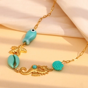 Detail of 18K gold-plated ocean necklace featuring turquoise fish, seahorse, and starfish