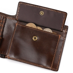 Detailed close-up of dark brown leather wallet showing coin pocket with snap closure