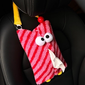 Pink striped plush monster car tissue holder hanging on the black leather headrest
