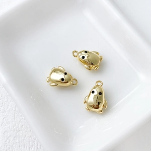 Detailed macro view of three 14k gold plated penguin charms for DIY jewelry making