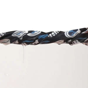 Detailed view showing the quick-dry breathable skull print cycling cap being wrung out