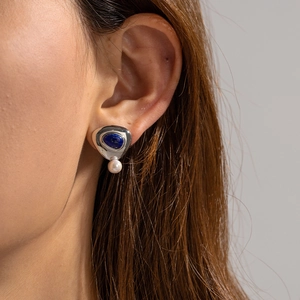 18K gold plated triangle stud earring with lapis lazuli and pearl on a model