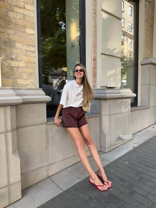 Oversize white T-shirt with purple letter embroidery paired with satin lace shorts