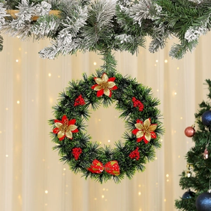 Close-up of a festive Christmas wreath with poinsettia flowers, red berries, and a bow