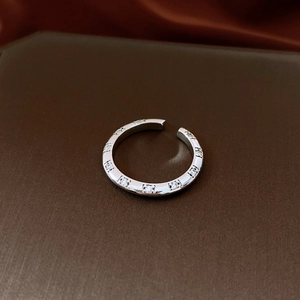 Detailed close-up of open ring showing square-set cubic zirconia and metallic texture