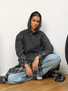 Oversized washed dark grey hoodie with vintage texture and American streetwear aesthetic