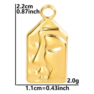 Detailed macro view of 18k gold plated abstract face pendant with hammered texture