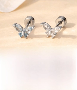 Macro detail of butterfly screw stud earrings with marquise zircon and silver titanium steel