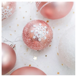 Close-up of pink and white Christmas tree balls with snowflake sequins on white gauze