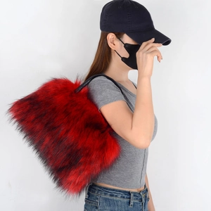 Detail of red and black faux fur tote bag showing the fluffy texture and leather handles