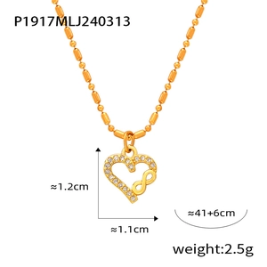 Detailed view of gold plated heart and infinity symbol pendant necklace with crystal accents