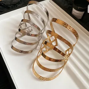 Irregular multilayer crossover wide bangle in gold and silver with hammered finish
