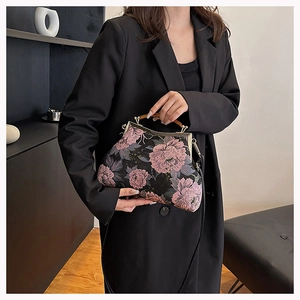 Elegant black embroidered qipao handbag with floral patterns and wooden handle