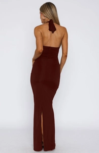 Detail of dark red backless maxi dress featuring halter neck and elegant ruching texture