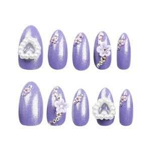 Handmade purple glitter press-on nails with white pearls, resin flowers, and rhinestones