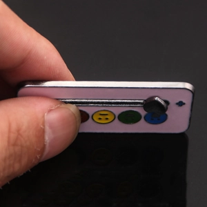 Macro shot of a manual slider mood brooch showing the social battery status icons