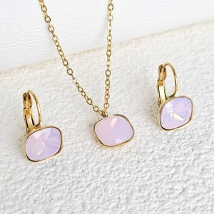Macro shot of 18k gold plated necklace and earrings with pink cushion cut zircons