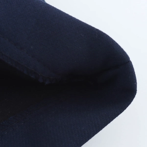 Close-up of high-quality dark blue fabric texture and professional overlock stitching detail