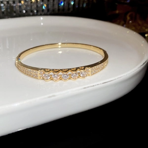 Detail of 18K gold plated bangle with sparkling cubic zirconia pavé setting craftsmanship