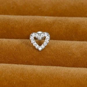 Macro detail of silver heart stud earrings with sparkling pavé cubic zirconia