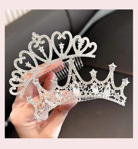 Detailed view of silver crystal tiara hair comb with heart and star patterns for girls