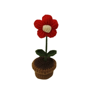 Handmade crochet potted red flower with green leaves in a brown knitted pot on white background