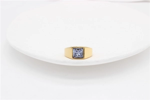 Detail of a gold titanium steel signet ring featuring a square light purple gemstone