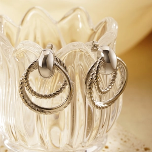 Retro geometric silver double hoop earrings with twisted metal texture on glass