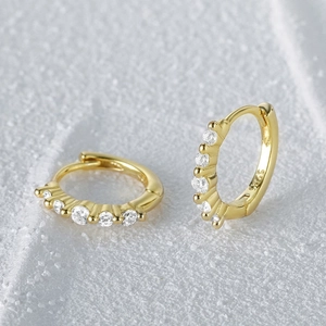 Detailed close-up of S925 sterling silver gold hoop earrings with white zircon stones
