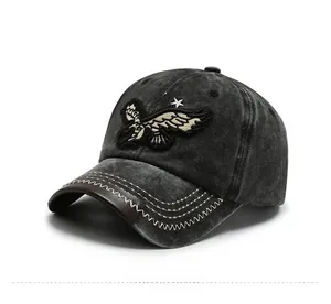 Detailed embroidery of an eagle and stars on a washed denim baseball cap in dark grey
