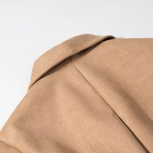 Detailed view of the back collar and shoulder seams of a vintage tan suede jacket