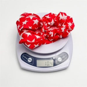 Close-up of USA flag pattern hair scrunchie weighing 10.4g on a digital scale