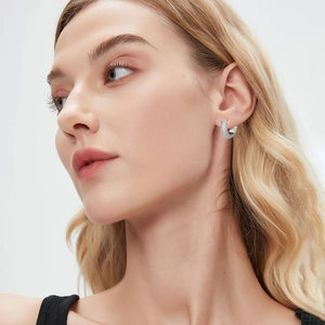Silver hoop earrings with sparkling cubic zirconia on model, luxury fashion jewelry