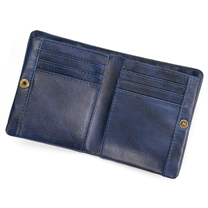 Close-up of open blue leather bifold wallet showing multiple card slots and snap closure
