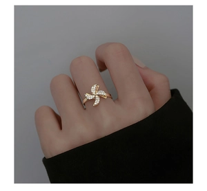 Detailed close-up of golden spinning windmill ring with sparkling inlaid zircon stones