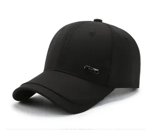 Detail of black cotton baseball cap with a dark metallic G.KATS brand plate on the side