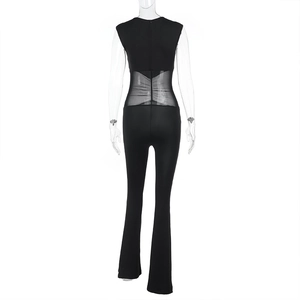 Rear view of mesh patchwork jumpsuit with sheer waist detail and flared pant leg