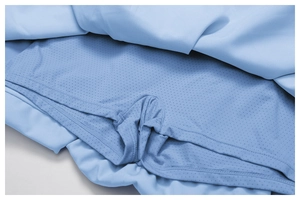 Detail of light blue tennis skirt featuring breathable inner mesh lining and professional stitching